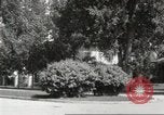 Image of An automobile almost hits pedestrians in center of a road Michigan United States USA, 1916, second 36 stock footage video 65675064462