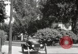 Image of An automobile almost hits pedestrians in center of a road Michigan United States USA, 1916, second 42 stock footage video 65675064462