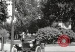 Image of An automobile almost hits pedestrians in center of a road Michigan United States USA, 1916, second 43 stock footage video 65675064462