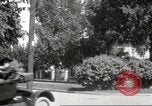 Image of An automobile almost hits pedestrians in center of a road Michigan United States USA, 1916, second 44 stock footage video 65675064462