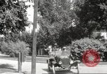 Image of An automobile almost hits pedestrians in center of a road Michigan United States USA, 1916, second 47 stock footage video 65675064462