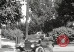 Image of An automobile almost hits pedestrians in center of a road Michigan United States USA, 1916, second 48 stock footage video 65675064462