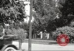 Image of An automobile almost hits pedestrians in center of a road Michigan United States USA, 1916, second 49 stock footage video 65675064462