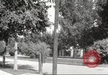 Image of An automobile almost hits pedestrians in center of a road Michigan United States USA, 1916, second 52 stock footage video 65675064462