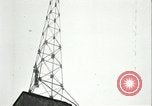 Image of U.S. troops raise flag on radio tower celebrating Armistice France, 1918, second 54 stock footage video 65675065322