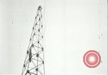 Image of U.S. troops raise flag on radio tower celebrating Armistice France, 1918, second 60 stock footage video 65675065322