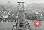 Image of Brooklyn Bridge and Williamsburg Bridge New York City USA, 1918, second 55 stock footage video 65675066758
