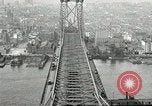Image of Brooklyn Bridge and Williamsburg Bridge New York City USA, 1918, second 57 stock footage video 65675066758