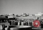 Image of Camels offered for sale at outdoor market in Marrakech Morocco North Africa, 1942, second 4 stock footage video 65675067433