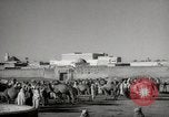 Image of Camels offered for sale at outdoor market in Marrakech Morocco North Africa, 1942, second 14 stock footage video 65675067433