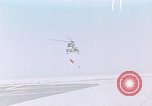 Image of CH-3 helicopter lowers BQM-34 F Firebee drone to ground California United States USA, 1971, second 1 stock footage video 65675067713