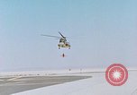 Image of CH-3 helicopter lowers BQM-34 F Firebee drone to ground California United States USA, 1971, second 4 stock footage video 65675067713