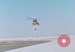 Image of CH-3 helicopter lowers BQM-34 F Firebee drone to ground California United States USA, 1971, second 5 stock footage video 65675067713