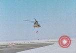 Image of CH-3 helicopter lowers BQM-34 F Firebee drone to ground California United States USA, 1971, second 6 stock footage video 65675067713