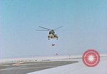 Image of CH-3 helicopter lowers BQM-34 F Firebee drone to ground California United States USA, 1971, second 7 stock footage video 65675067713