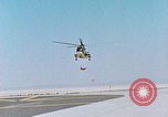Image of CH-3 helicopter lowers BQM-34 F Firebee drone to ground California United States USA, 1971, second 8 stock footage video 65675067713