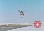 Image of CH-3 helicopter lowers BQM-34 F Firebee drone to ground California United States USA, 1971, second 9 stock footage video 65675067713