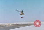 Image of CH-3 helicopter lowers BQM-34 F Firebee drone to ground California United States USA, 1971, second 10 stock footage video 65675067713