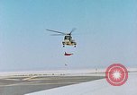 Image of CH-3 helicopter lowers BQM-34 F Firebee drone to ground California United States USA, 1971, second 12 stock footage video 65675067713