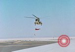 Image of CH-3 helicopter lowers BQM-34 F Firebee drone to ground California United States USA, 1971, second 13 stock footage video 65675067713
