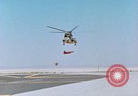 Image of CH-3 helicopter lowers BQM-34 F Firebee drone to ground California United States USA, 1971, second 14 stock footage video 65675067713