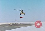 Image of CH-3 helicopter lowers BQM-34 F Firebee drone to ground California United States USA, 1971, second 15 stock footage video 65675067713