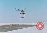 Image of CH-3 helicopter lowers BQM-34 F Firebee drone to ground California United States USA, 1971, second 16 stock footage video 65675067713