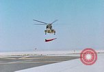 Image of CH-3 helicopter lowers BQM-34 F Firebee drone to ground California United States USA, 1971, second 18 stock footage video 65675067713