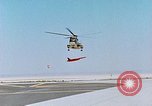 Image of CH-3 helicopter lowers BQM-34 F Firebee drone to ground California United States USA, 1971, second 19 stock footage video 65675067713
