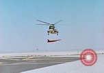 Image of CH-3 helicopter lowers BQM-34 F Firebee drone to ground California United States USA, 1971, second 20 stock footage video 65675067713