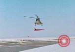 Image of CH-3 helicopter lowers BQM-34 F Firebee drone to ground California United States USA, 1971, second 21 stock footage video 65675067713
