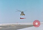 Image of CH-3 helicopter lowers BQM-34 F Firebee drone to ground California United States USA, 1971, second 22 stock footage video 65675067713