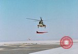 Image of CH-3 helicopter lowers BQM-34 F Firebee drone to ground California United States USA, 1971, second 23 stock footage video 65675067713