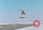Image of CH-3 helicopter lowers BQM-34 F Firebee drone to ground California United States USA, 1971, second 24 stock footage video 65675067713