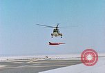 Image of CH-3 helicopter lowers BQM-34 F Firebee drone to ground California United States USA, 1971, second 25 stock footage video 65675067713