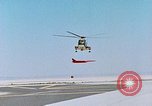 Image of CH-3 helicopter lowers BQM-34 F Firebee drone to ground California United States USA, 1971, second 26 stock footage video 65675067713