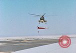 Image of CH-3 helicopter lowers BQM-34 F Firebee drone to ground California United States USA, 1971, second 27 stock footage video 65675067713