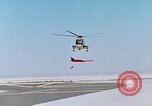 Image of CH-3 helicopter lowers BQM-34 F Firebee drone to ground California United States USA, 1971, second 28 stock footage video 65675067713