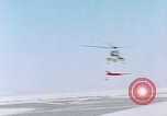 Image of CH-3 helicopter lowers BQM-34 F Firebee drone to ground California United States USA, 1971, second 29 stock footage video 65675067713