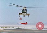 Image of CH-3 helicopter lowers BQM-34 F Firebee drone to ground California United States USA, 1971, second 33 stock footage video 65675067713