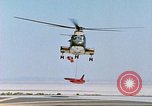 Image of CH-3 helicopter lowers BQM-34 F Firebee drone to ground California United States USA, 1971, second 34 stock footage video 65675067713