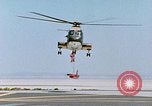 Image of CH-3 helicopter lowers BQM-34 F Firebee drone to ground California United States USA, 1971, second 35 stock footage video 65675067713