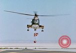 Image of CH-3 helicopter lowers BQM-34 F Firebee drone to ground California United States USA, 1971, second 36 stock footage video 65675067713