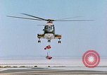 Image of CH-3 helicopter lowers BQM-34 F Firebee drone to ground California United States USA, 1971, second 37 stock footage video 65675067713