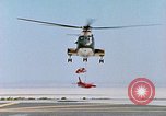 Image of CH-3 helicopter lowers BQM-34 F Firebee drone to ground California United States USA, 1971, second 38 stock footage video 65675067713
