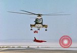 Image of CH-3 helicopter lowers BQM-34 F Firebee drone to ground California United States USA, 1971, second 39 stock footage video 65675067713