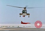 Image of CH-3 helicopter lowers BQM-34 F Firebee drone to ground California United States USA, 1971, second 40 stock footage video 65675067713