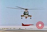 Image of CH-3 helicopter lowers BQM-34 F Firebee drone to ground California United States USA, 1971, second 41 stock footage video 65675067713