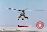 Image of CH-3 helicopter lowers BQM-34 F Firebee drone to ground California United States USA, 1971, second 42 stock footage video 65675067713