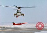 Image of CH-3 helicopter lowers BQM-34 F Firebee drone to ground California United States USA, 1971, second 45 stock footage video 65675067713